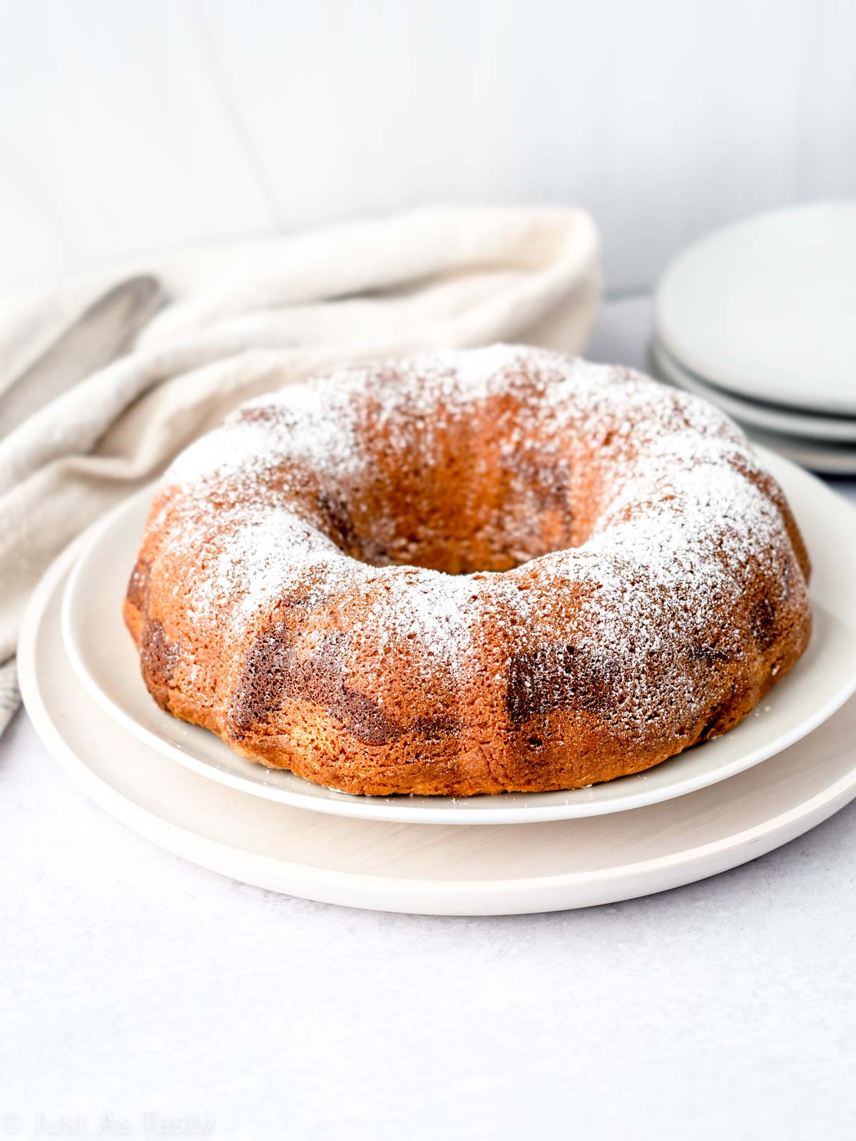 Marble bundt cake topped with powdered sugar. 
