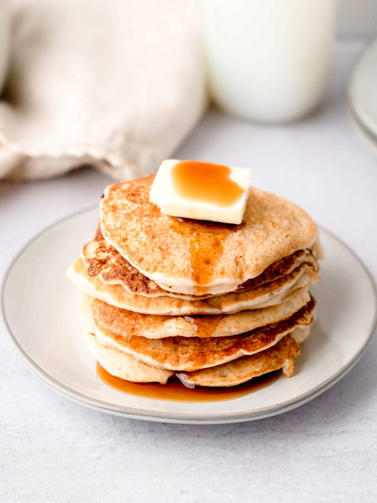 Stack of gluten free pancakes on a plate.