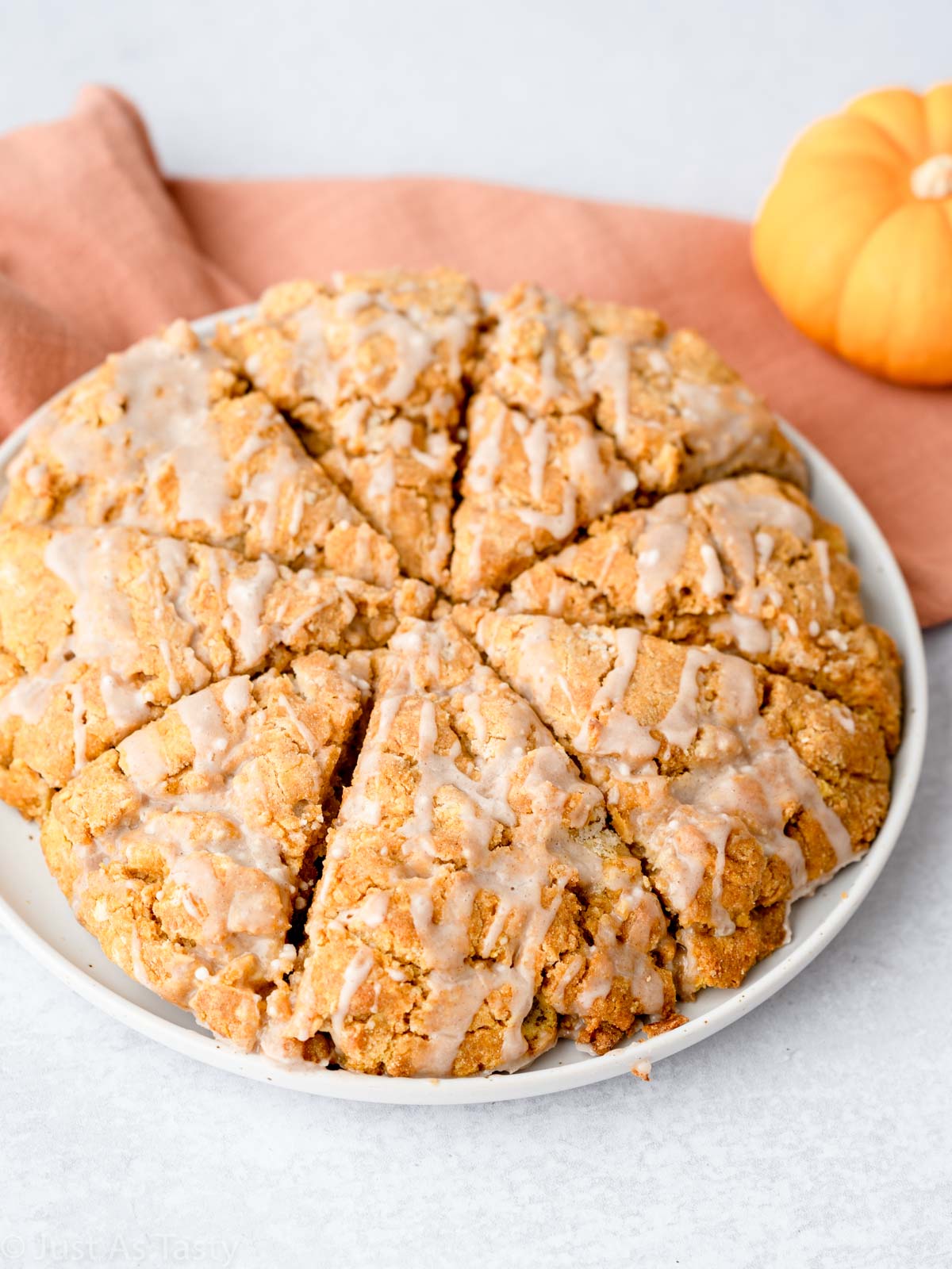 Glazed gluten free pumpkin scones on a plate. 