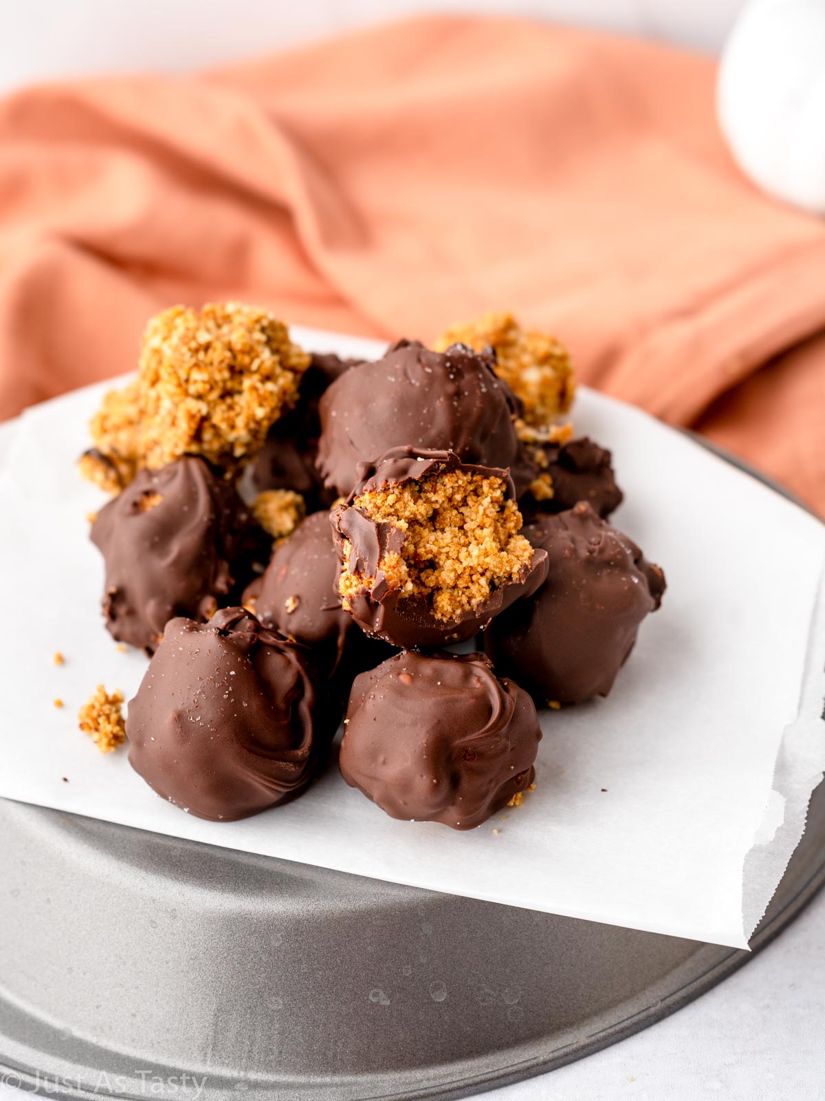 No bake pumpkin truffles on parchment paper. 