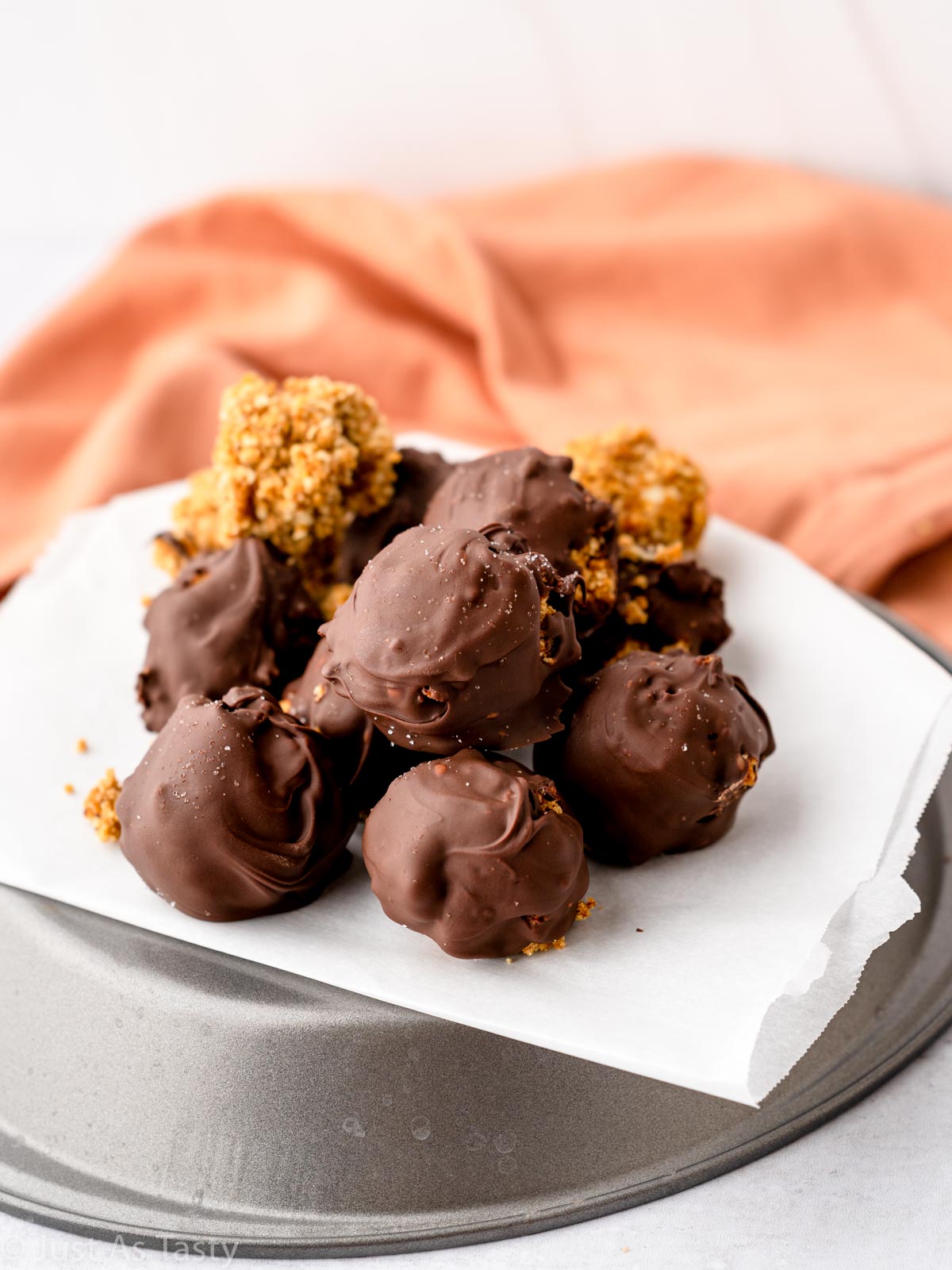 Chocolate covered pumpkin truffles on parchment.