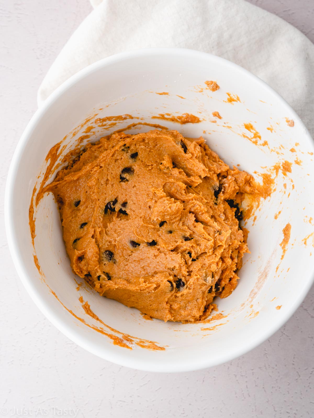 Pumpkin bread batter with chocolate chips in a bowl.