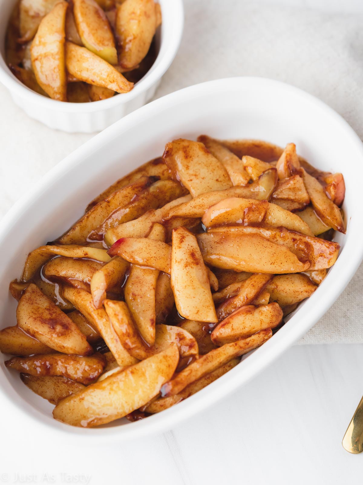 Air fryer apples in a white bowl. 