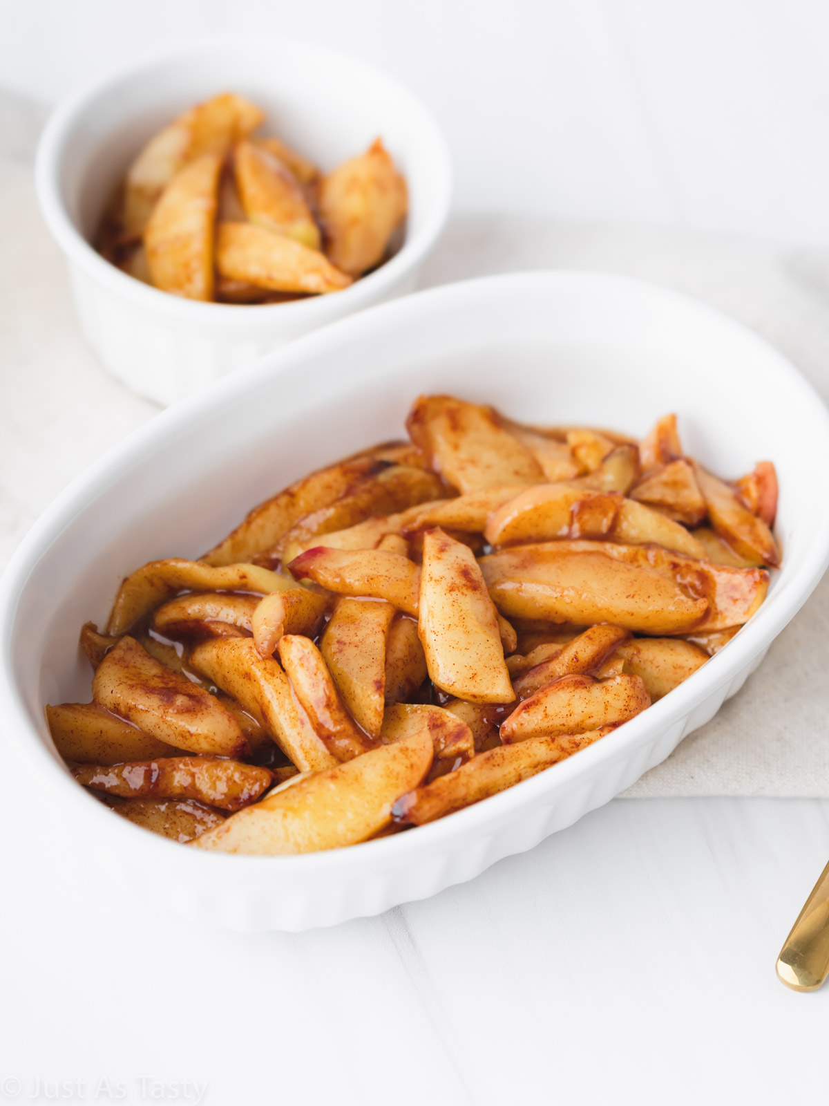 Air fryer apples in a white bowl. 