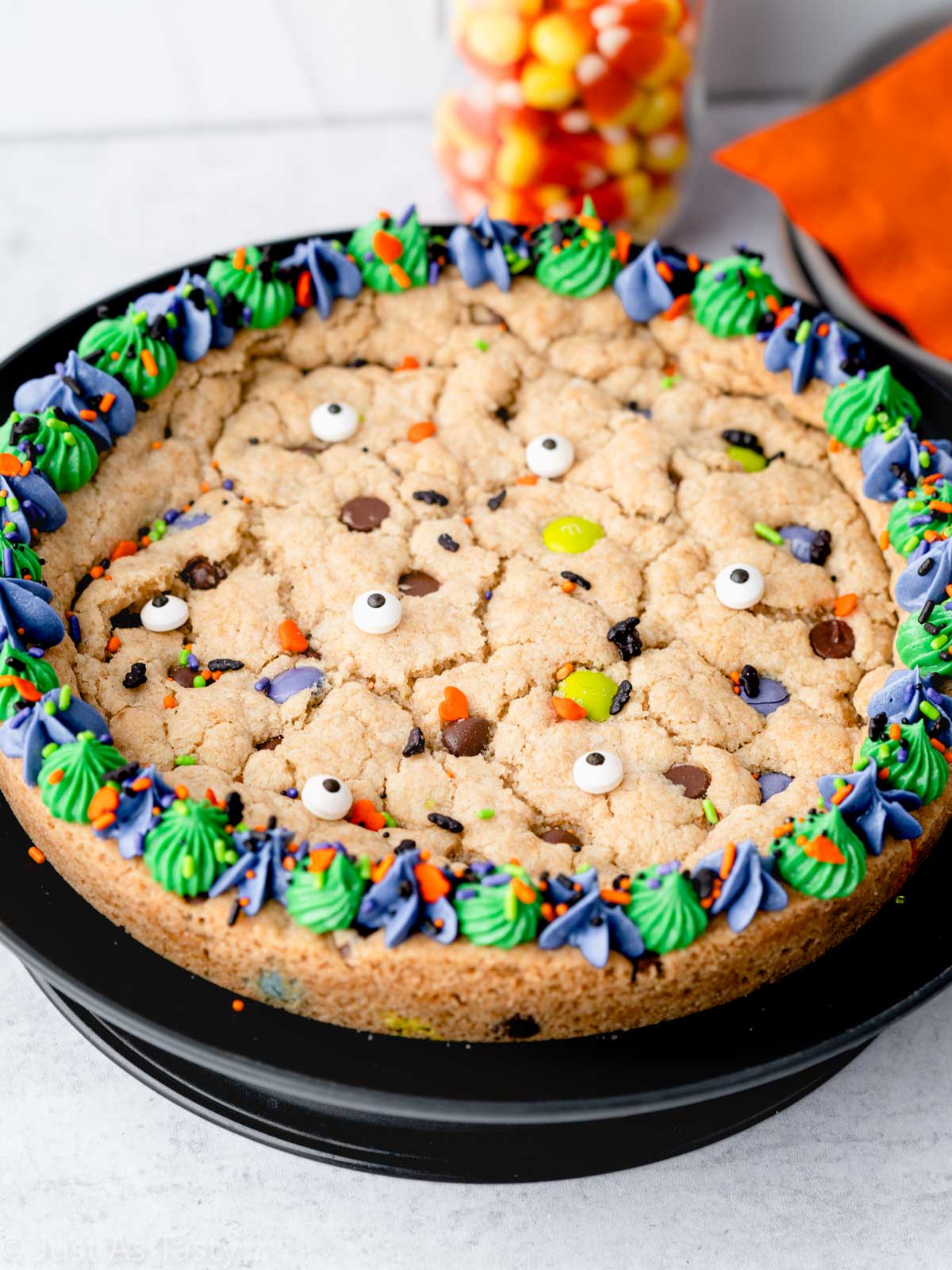 Halloween cookie cake on a black plate. 