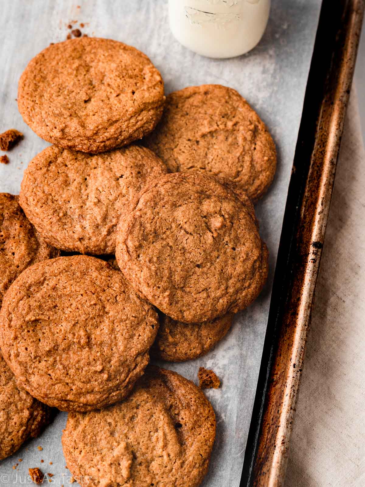 Maple sugar cookies on a lined baking sheet. 