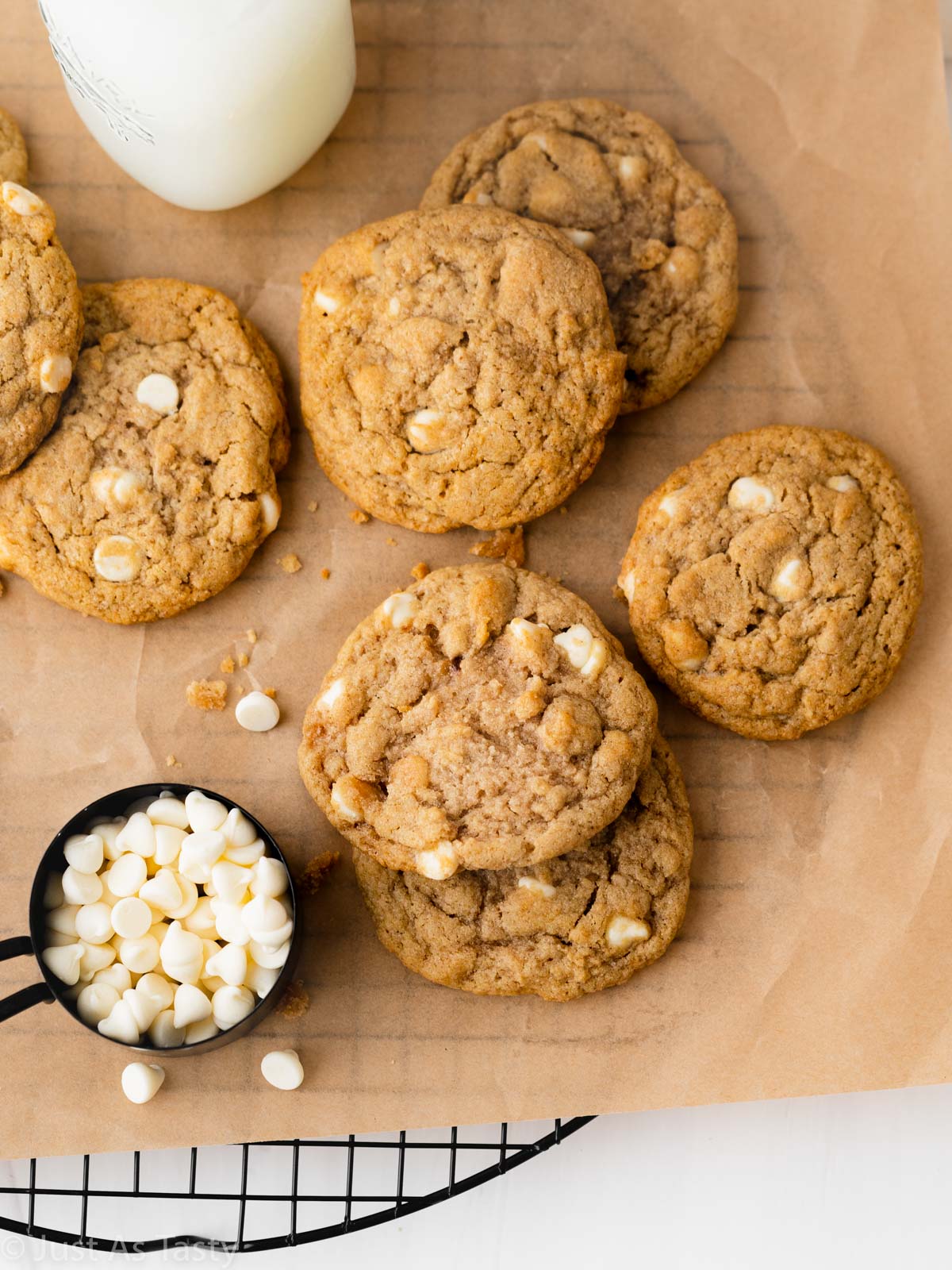 Apple pie cookies with white chocolate chips on brown parchment paper.