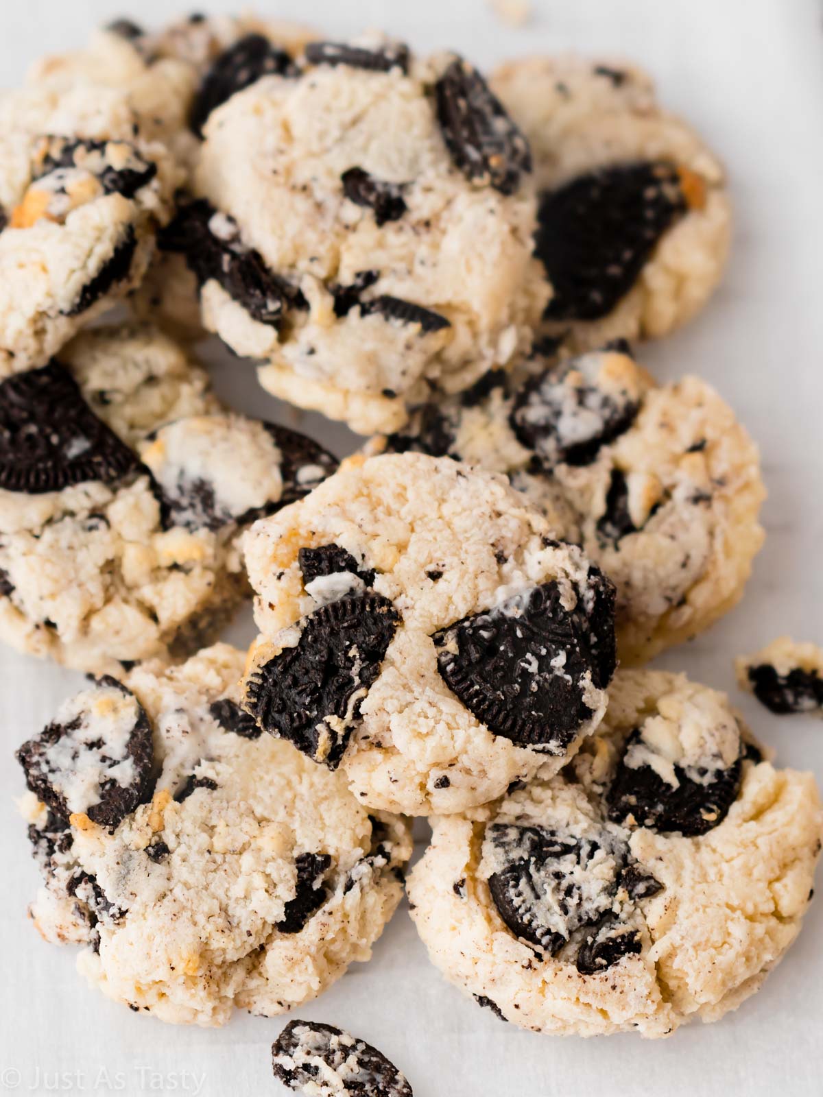Pile of Oreo cheesecake cookies on parchment. 