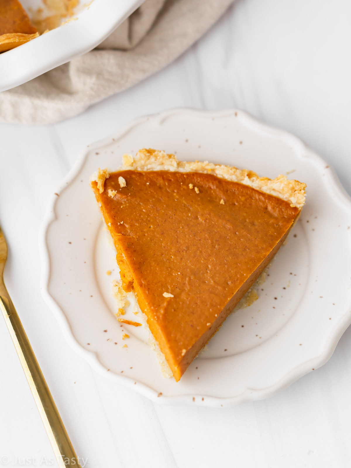 Close-up of a slice of pumpkin pie on a plate. 