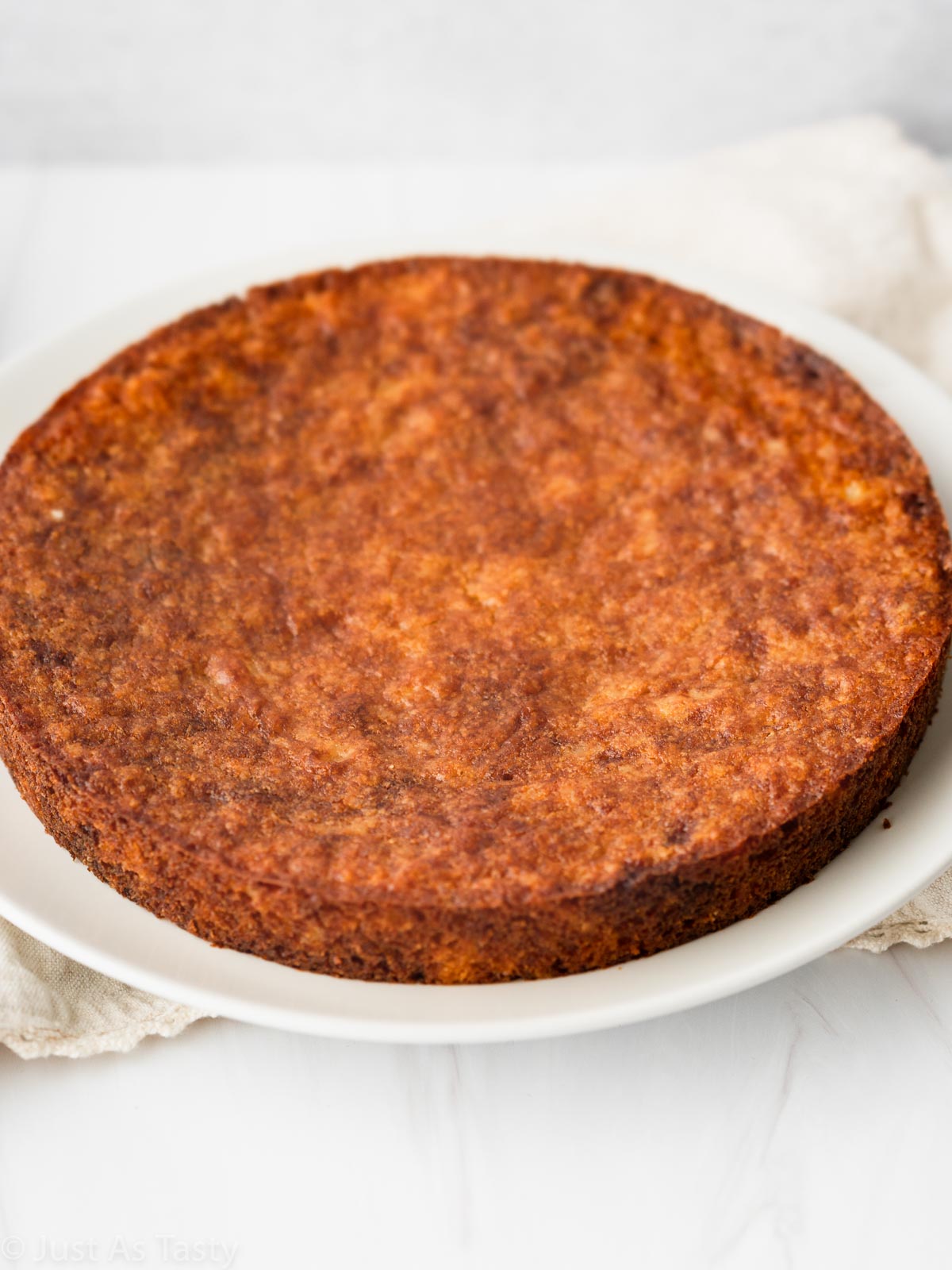 Olive oil cake on a white plate. 