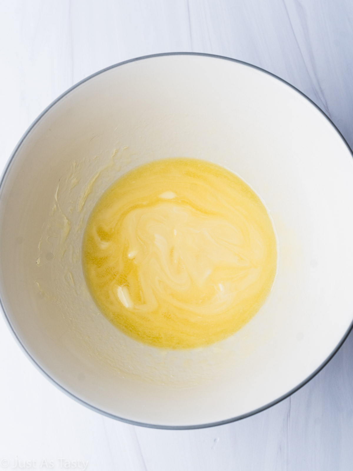 Melted butter and white chocolate in a bowl.