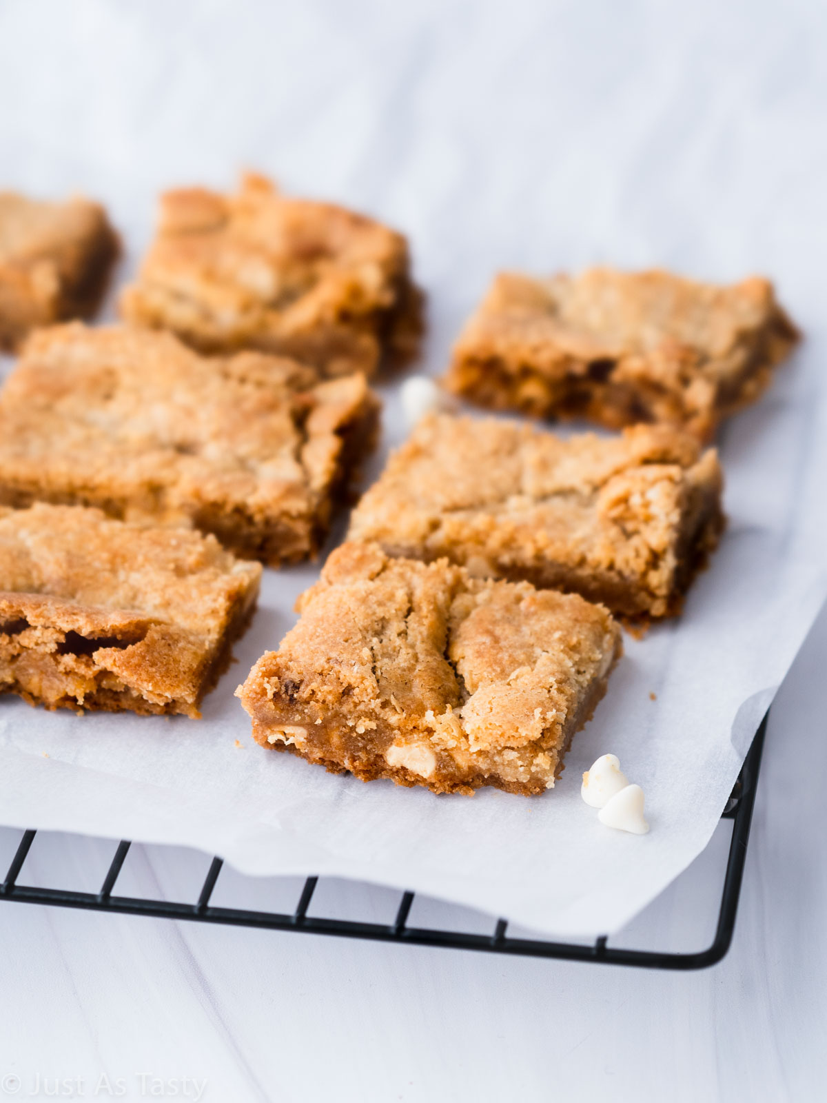 White chocolate brownies on a cooling rack. 