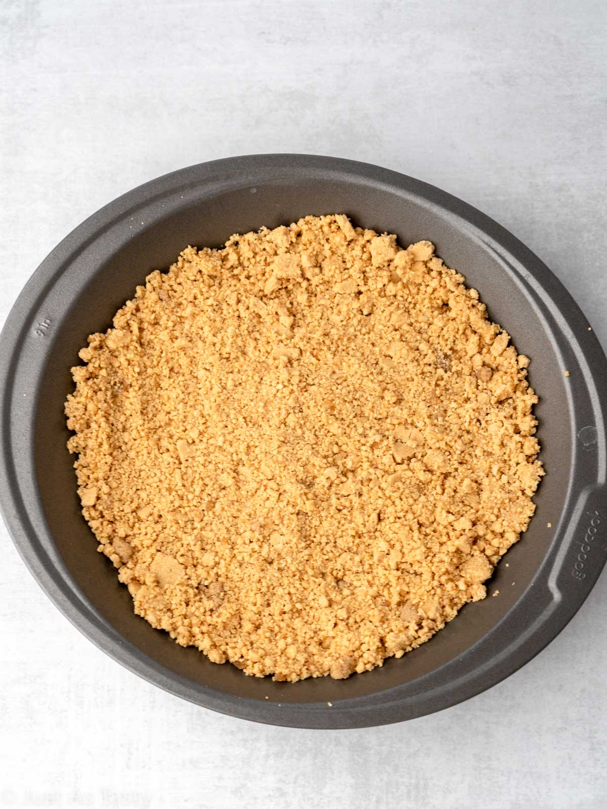 Gluten free graham cracker crust in a pie dish. 