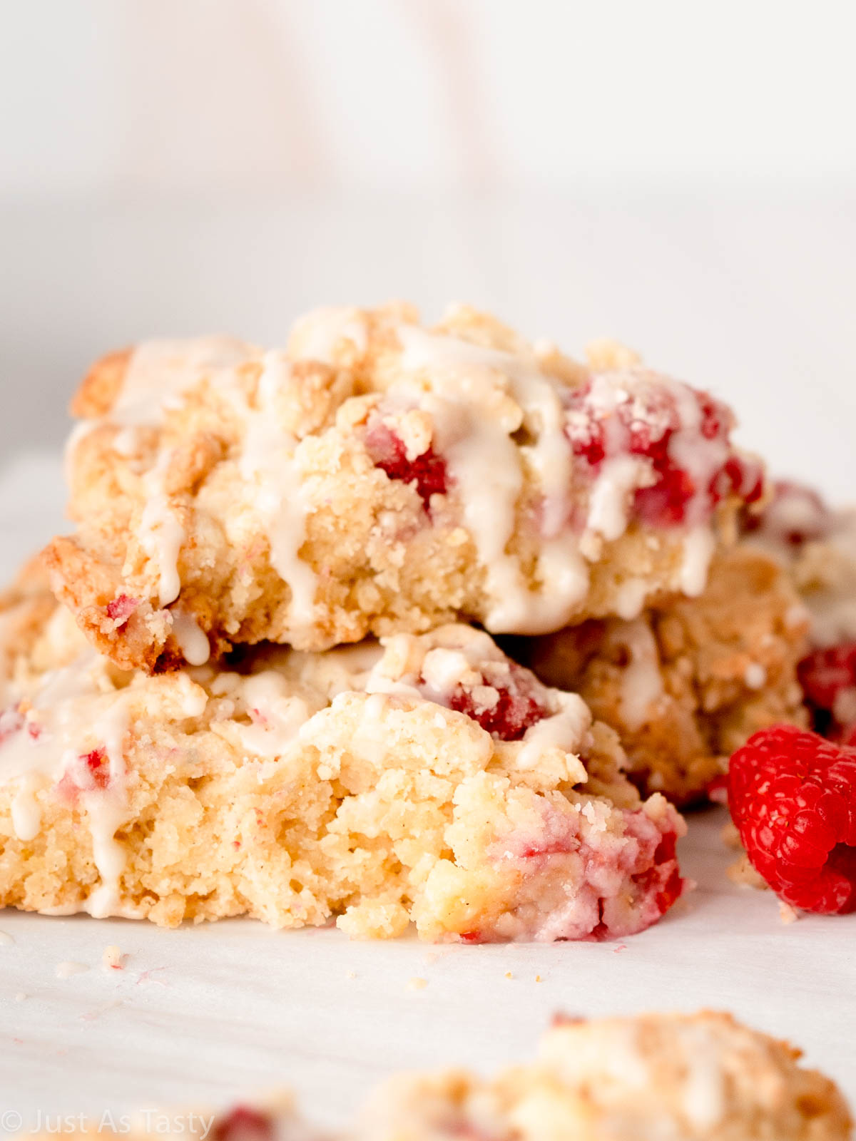 White chocolate raspberry scones stacked on top of each other. 