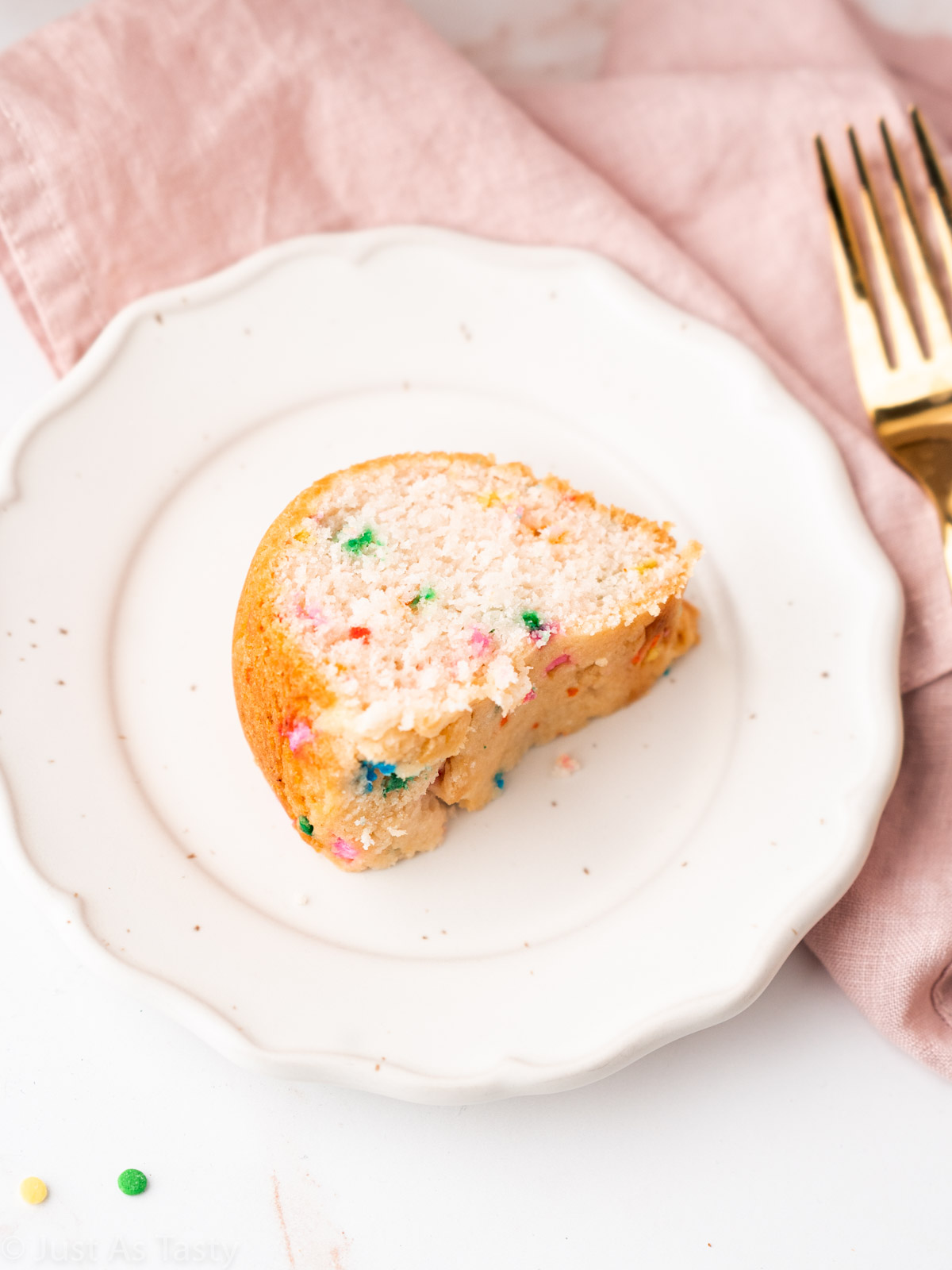 Close-up of a slice of funfetti Bundt cake using cake mix on a plate. 
