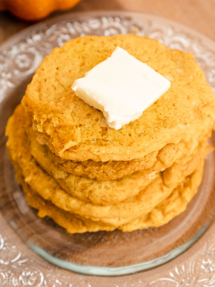 Close-up of a stack of gluten free pancakes with butter on top.